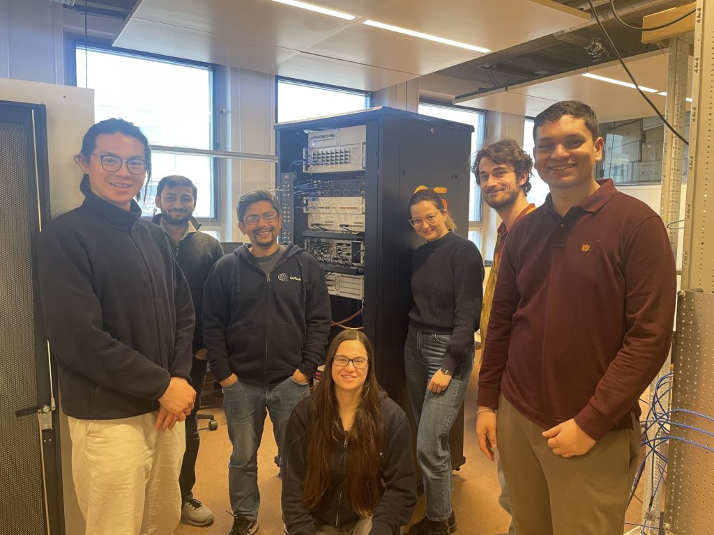 Caption: Group picture of the OrangeQS delivery team together with students and researchers from the Andersen Lab and the Goswami Lab at QuTech.